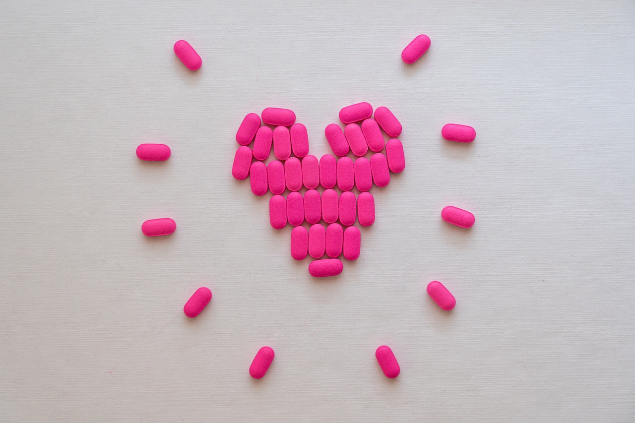 Pink pills in the shape of a heart